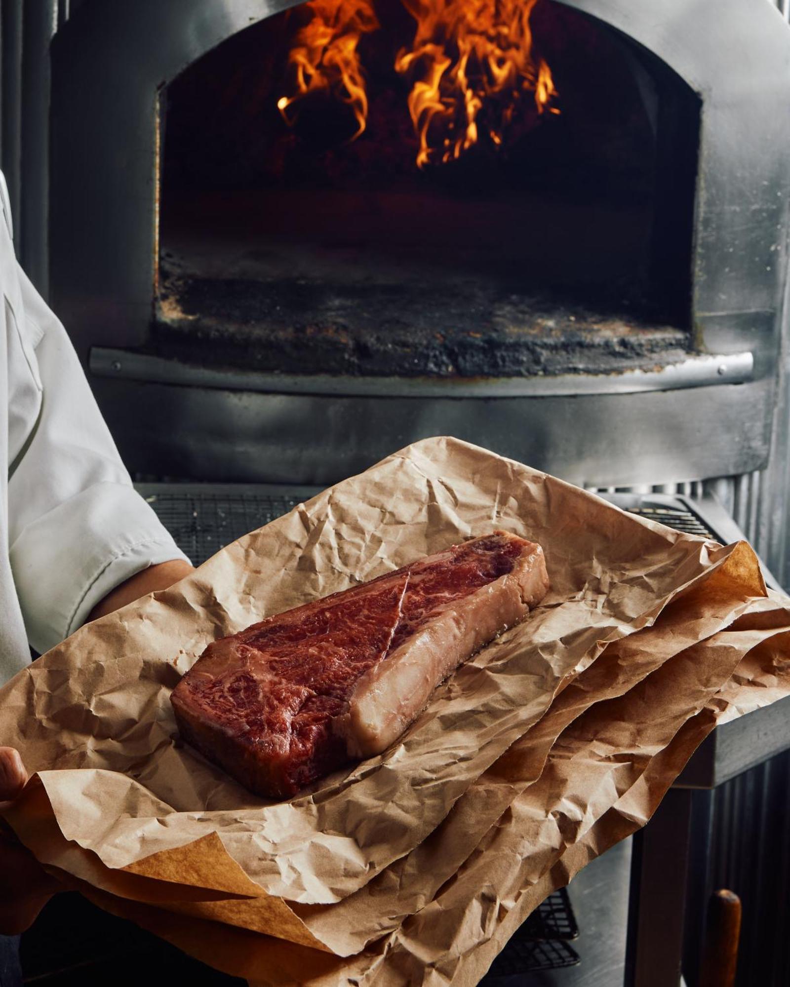 Park Hyatt Melbourne Hotel Eksteriør billede A steak being removed from a wood-fired oven